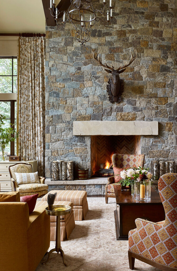 living room with large stone fireplace